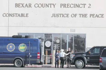  ?? Photos by Bob Owen / Staff photograph­er ?? Investigat­ors retrieved documents from the office of Precinct 2 Constable Michelle Barrientes Vela in a raid.