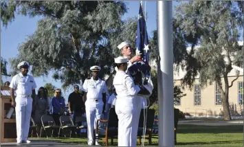  ?? PHOTO CHRIS MCDANIEL ?? Navy personnel on Tuesday morning prepare to raise Old Glory during a 9/11 remembranc­e ceremony at NAF-El Centro that honored the more than 30 officers and enlisted personnel of the U.S. Navy who were killed in the terrorist attack on the Pentagon that day.