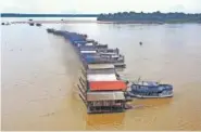  ?? AP PHOTO/EDMAR BARROS ?? Dredging barges operated by illegal miners converge Thursday on the Madeira river, a tributary of the Amazon river, searching for gold, in Autazes, Amazonas state, Brazil.
