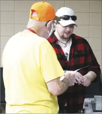  ?? Brodie Johnson • Times-Herald ?? St. Francis County Election worker Scott Young, right, assists a voter in casting his ballot this morning at the courthouse. Early voting opened today across the state to allow residents to begin casting ballots ahead of the May 24 primary. Early voting will be held each weekday, from 8 a.m. to 6 p.m., and on Saturdays from 10 a.m. to 4 p.m.