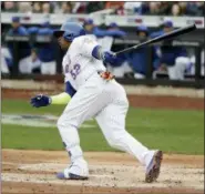  ?? FRANK FRANKLIN II — THE ASSOCIATED PRESS ?? Yoenis Cespedes follows through on a two-run single during Mets’ victory over Cardinals.