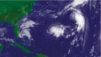  ??  ?? All together now: Tropical Depression Sixteen (left),Tropical Storm Nate (center), and Hurricane Maria in 2017
