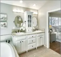  ??  ?? The master en suite bathroom features a dual sink vanity and large soaking tub.