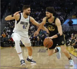  ?? JANE TYSKA — BAY AREA NEWS GROUP ?? The Warriors’ Klay Thompson (11) is guarded by the Mavericks’ Maxi Kleber (42) in the second quarter of Tuesday’s game at Chase Center in San Francisco.