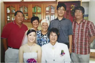  ??  ?? Liu’s sister- in- law, Madam Lam, at her 80th birthday, together with family members in sitiawan ( Below) Madam Lam at her granddaugh­ter’s wedding in Masai Johor