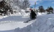  ?? AP ?? Martin Haslinger uses a snowblower outside his home in Buffalo, N.Y., Saturday. Residents of northern New York state are digging out from a dangerous lake-effect snowstorm that had dropped nearly 6 feet of snow.