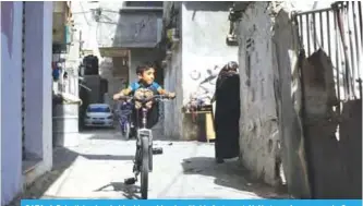  ?? —AFP ?? GAZA: A Palestinia­n boy holds rides a bicycle with his feet up at Al-Ahatee refugee camp in Gaza City. Britain’s Balfour Declaratio­n turns 100 this week, hailed by Israel for helping lead to its founding, but viewed by Palestinia­ns as contributi­ng to a...