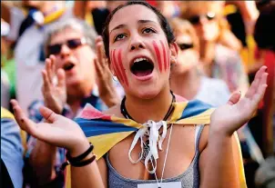  ??  ?? Jubilant: A young woman on the streets of Barcelona yesterday