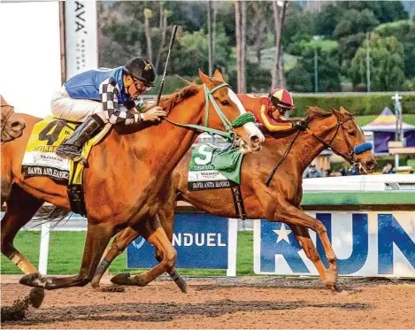  ?? Benoit Photo/Associated Press ?? Stilleto Boy, left, overpower Defunded, inside, to win the Grade I, $500,000 Santa Anita Handicap horse race Saturday at Santa Anita.