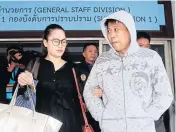  ?? THANARAK KHUNTON ?? Kim Seungcheul, right, leaves the Crime Suppressio­n Division’s 1st sub-division after being questioned by police. Police want to detain him for 12 more days in relation to the kidnapping of three fellow nationals for ransom.