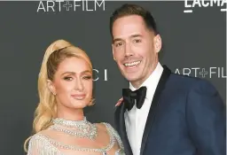  ?? RICHARD SHOTWELL/INVISION 2021 ?? Paris Hilton, left, and husband Carter Reum have welcomed their first child, a boy.