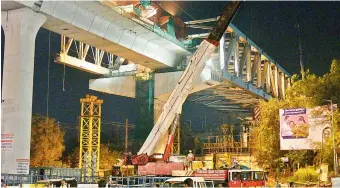  ?? — DECCAN CHRONICLE ?? HMRL engineers work on the steel bridge over Oliphanta Road-over-Bridge where Metro Rail tracks are being laid, on Wednesday. The steel bridge was successful­ly installed on August 14. Engineers said that a small part will be opened for smaller vehicles within a week.