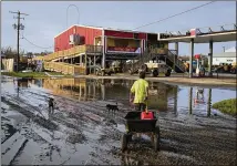  ?? JOHN LOCHER/ASSOCIATED PRESS ?? A man goes for gas Monday at a hurricane-damaged gas station in the
aftermath of Hurricane Ida in Grand Isle, Louisiana. Fuel shortages persisted across areas of the state.