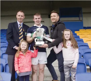  ??  ?? Bray’s Marc Lennon receives the cup after victory over Glenealy in the 2019 final.