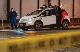  ?? Loren Elliott/ Special to the Chronicle ?? Law enforcemen­t personnel work at the scene where a person had been trapped underneath a Cruise vehicle on Oct. 2. Cruise’s operations in the city were suspended after the accident.