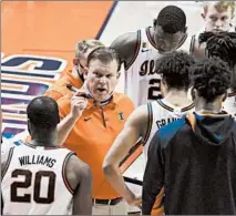  ?? HOLLY HART/AP ?? Illinois coach Brad Underwood talks with his team during a timeout in Saturday’s game against Ohio State in Champaign.