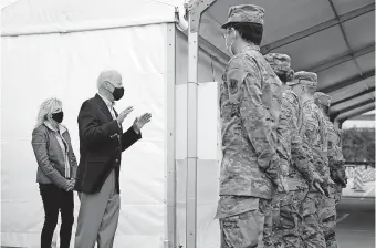  ?? [PATRICK SEMANSKY/ THE ASSOCIATED PRESS] ?? President Joe Biden and first lady Jill Biden meet with troops at a FEMA COVID-19 mass vaccinatio­n site at NRG Stadium, Friday in Houston.