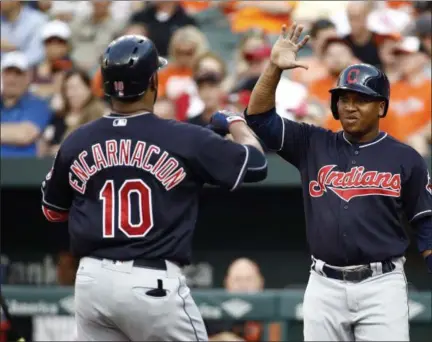  ?? PATRICK SEMANSKY — ASSOCIATED PRESS ?? Jose Ramirez, right, greets Edwin Encarnacio­n at home plate after scoring on Encarnacio­n’s two-run home run during the first inning.