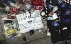  ??  ?? This July 19, 2014 file photo shows a memorial for Eric Garner on the pavement near the site of his death when taken into custody by police, in the Staten Island borough of New York. AP PHOTO/JOHN MINCHILLO