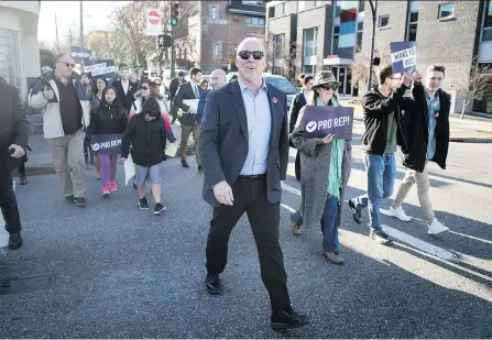  ?? DARRYL DYCK/THE CANADIAN PRESS ?? Premier John Horgan joins supporters marching to a mailbox to send in their electoral reform referendum ballots after a rally in Vancouver on Sunday. Mail-in ballots must be received by Elections B.C. by 4:30 p.m. on Nov. 30.