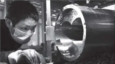  ?? Cnsphoto Photo: ?? A worker at a factory in Zhoushan, East China’s Zhejiang Province, produces a molding machine screw on Thursday. Currently, many enterprise­s and factories nationwide have resumed production, while carefully ensuring containmen­t of the CODIV-19 spreading.