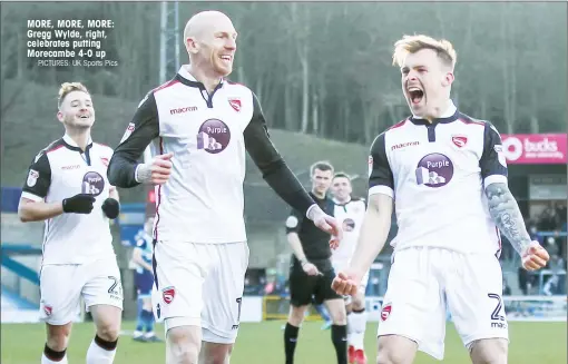  ?? PICTURES: UK Sports Pics ?? MORE, MORE, MORE: Gregg Wylde, right, celebrates putting Morecambe 4-0 up