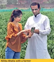  ??  ?? Nitika Bhatia with a farmer