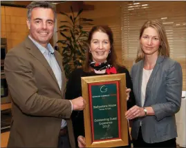  ??  ?? Justin and Jenny Greene from Ballyvolan­e House receiving their ‘Outstandin­g Guest Experience’ award from Georgina Campbell.