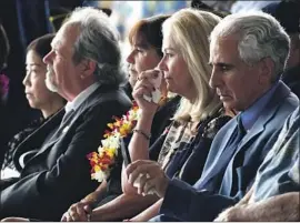  ?? Susan Walsh Associated Press ?? DIANA BROWN SANFILIPPO, second from right, whose father, Army 1st Lt. Frank Salazar, is among the Korean War missing, attends the ceremony.