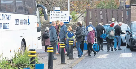  ?? Picture: Dougie Nicolson. ?? Passengers being directed on to the replacemen­t buses outside Perth Railway Station.