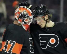  ?? TOM MIHALEK — THE ASSOCIATED PRESS ?? Philadelph­ia Flyers’ Brian Elliott, left, and Nolan Patrick celebrate the 5-2 win over the New Jersey Devils on Saturday in Philadelph­ia.