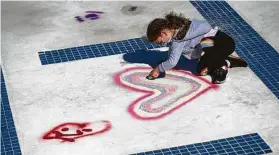  ?? Marie D. De Jesús / Staff photograph­er ?? A girl draws in the outdoor pool during groundbrea­king celebratio­n events at the Evelyn Rubenstein Jewish Community Center in Houston on Sunday.