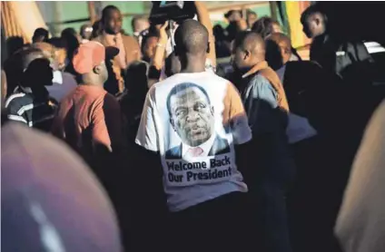  ??  ?? Watch your back: Emmerson Mnangagwa may have succeeded Robert Mugabe but his role in the Gukurahund­i massacre cannot easily be forgotten. Photo: Marco Longari/AFP