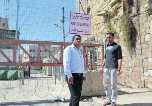  ?? Photos Kate Shuttlewor­th for The National ?? Hazem Abu Rajab, 28, right, with Badee Dwaik, the Palestinia­n human-rights activist helping the family members who are being threatened by the Israeli army and Jewish settlers, with eviction from their home in the H2 area of Hebron.