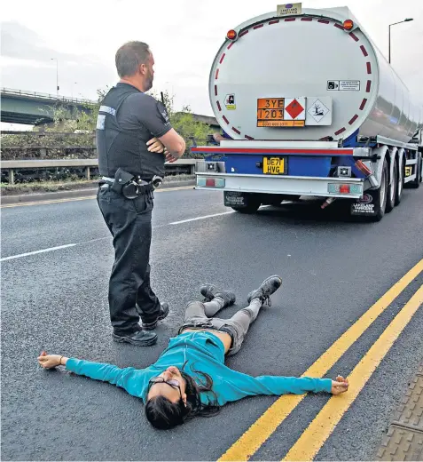  ?? ?? Activists from Just Stop Oil try to block the main road to the Navigator oil storage depot in Grays, Essex. Priti Patel, the Home Secretary, said that ‘they should all be stopped’