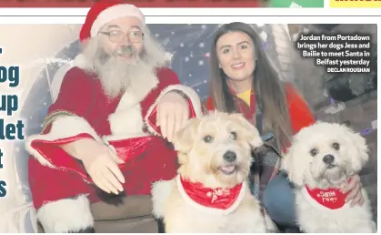  ?? DECLAN ROUGHAN ?? Jordan from Portadown brings her dogs Jess and Bailie to meet Santa in
Belfast yesterday