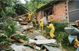  ?? ANDRE PENNER/AP ?? Rescue workers search for survivors Monday after flooding triggered deadly landslides near Juquehy beach in Sao Sebastiao, Brazil. Nearly 800 people are homeless.