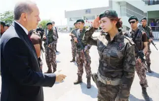  ??  ?? RESPECT: Turkey President Recep Tayyip Erdogan greets a commando at the special forces headquarte­rs in Ankara. (AP)