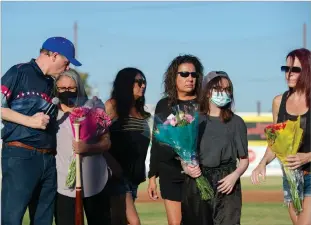  ?? Photos by Chris Kaufman/ Appeal ?? Yuba-sutter Gold Sox managing general partner John Cassidy, left, hugs Paula Duron, Michael Raymond Sanchez’s mother before Thursday’s game at Colusa Casino Stadium in Marysville.
Anita Sanchez and Jennifer Crawford, Sanchez’s sisters; Aven Sanchez, his daughter; and Connie Bernethy, his girlfriend. Managing general partner Tom Lininger, center, presents a baseball bat to the family of Michael Sanchez before Thursday’s game at Colusa Casino Stadium in Marysville. Sanchez, who died on Tuesday, was the team photograph­er for the past two seasons.