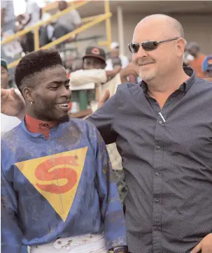  ?? IAN ALLEN ?? Apprentice Linton Steadman (left) and trainer Anthony Nunes celebrate after SOTOMAYOR won yesterday’s 105th running of the Supreme Ventures 2-Y-O Stakes at Caymanas Park.