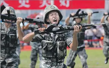  ?? Kin Cheung Associated Press ?? SOLDIERS WITH the People’s Liberation Army stage a demonstrat­ion in Hong Kong. A commander referred to the Hong Kong protests as “intolerabl­e” and said the military was prepared to help maintain order.