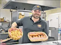  ?? DESIREE ANSTEY/ JOURNAL PIONEER ?? Rami Ayoub, owner of Dino’s Pizza restaurant in Summerside, displays his number one selling product on Good Friday.