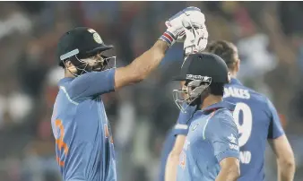  ??  ?? India’s Kedar Jadhav, right, celebrates with captain Virat Kohli after reaching his century