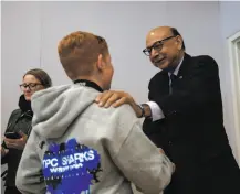 ?? Gabrielle Lurie / The Chronicle ?? Khizr Khan, noted Muslim American Gold Star father, talks with Hayden Abbott,13, at Hall Middle School in Larkspur.