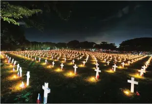  ??  ?? MANILA: Thousands of crosses are lit with candles to pay tribute to the departed soldiers in observance of All Saints Day at the Heroes Cemetery yesterday in suburban Taguig city, east of Manila, Philippine­s. Families bring flowers. Relatives seek out...