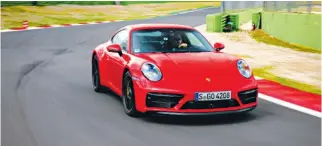  ?? ?? The author rounds a curve at the Autodromo Vallelunga in Italy behind the wheel of a Porsche 911 GTS.