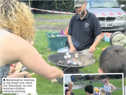 ??  ?? Marshmallo­w toasting in the firepit and, inset, Cllr Waterfield, far end, watches children enjoying painting