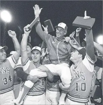  ?? Associated Press ?? THE MAN who lifted Cal State Fullerton baseball from obscurity to national prominence was Augie Garrido, center. He coached the Titans to three NCAA titles, including in 1984, above, in his 21 seasons.