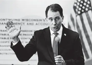  ?? JIM MATTHEWS/AP ?? Wisconsin Gov. Scott Walker defends the measures he signed as improving transparen­cy, stability and accountabi­lity.