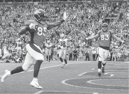  ?? MATTHEW STOCKMAN/GETTY IMAGES ?? Denver Broncos tight end Virgil Green scores a touchdown against the Dallas Cowboys in the third quarter on Sunday in Denver. Green’s TD was one of four thrown by quarterbac­k Trevor Siemian in the Broncos’ 42-17 blowout win over the Cowboys.